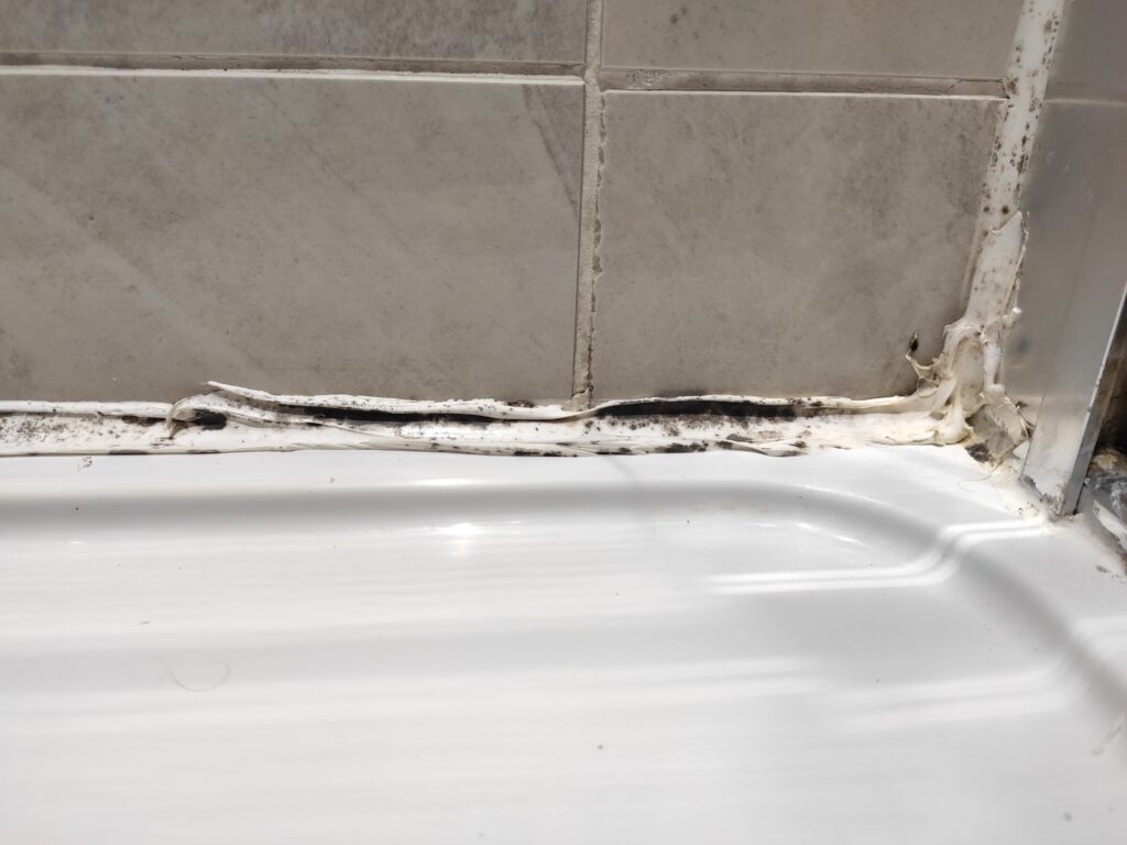 mouldy, cracked silicone, sealant needs replacement