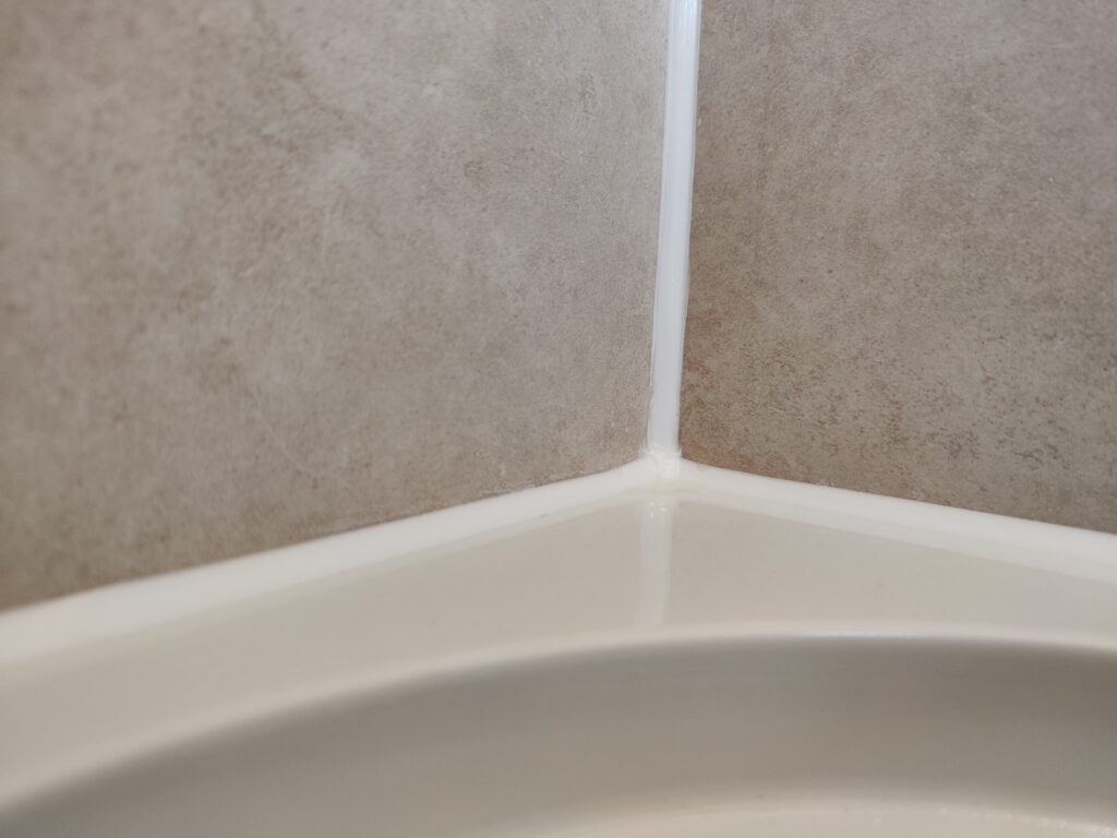 Clean and perfect sealant, silicone, mastic in bathroom